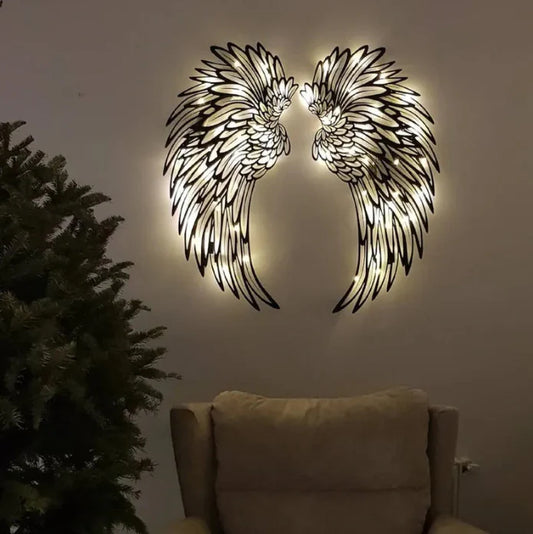 Carved metal angel wings wall decor with LED light in dark room
