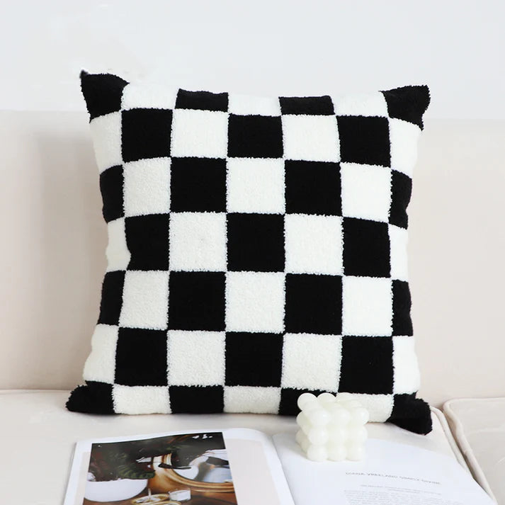 Black and white checkerboard throw pillow on sofa