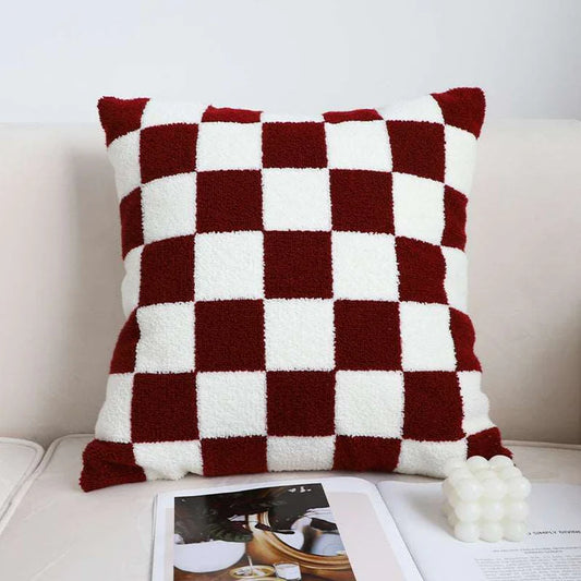 Brown and white checkerboard throw pillow on sofa