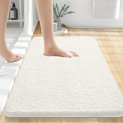 Beige chenille floor mat placed in front of a shower in a clean modern bathroom
