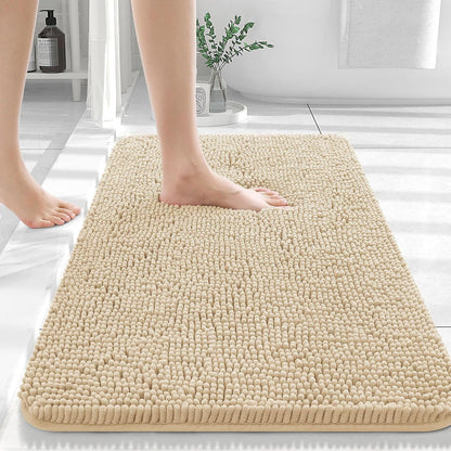 Camel colored chenille floor mat on dark hardwood flooring beside a bathroom vanity

