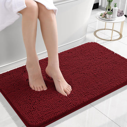 Dark red chenille floor mat used in a home entryway on light tile flooring
