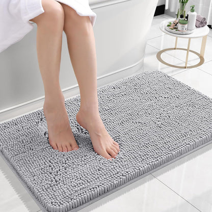 Silver gray chenille floor mat beside a bed used as a soft bedroom pedal mat
