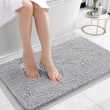 Silver gray chenille floor mat beside a bed used as a soft bedroom pedal mat