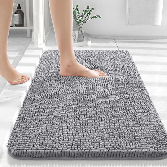 Silver gray chenille floor mat beside a bed used as a soft bedroom pedal mat
