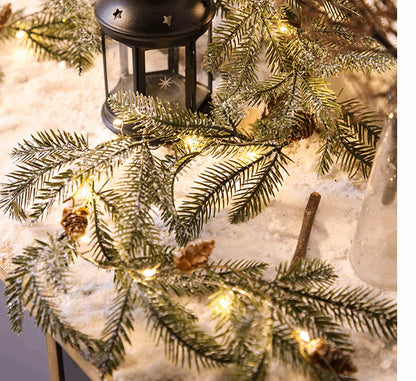 Christmas pine cone garland with candles and warm glow
