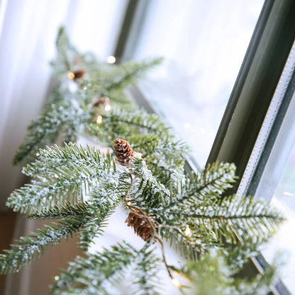 Christmas pine cone garland glowing warm at night