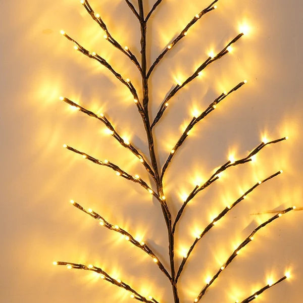 Christmas branch tree lamp glowing with warm LED lights for indoor bedroom decor
