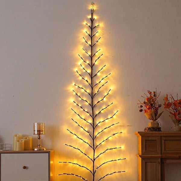 Tall rattan Christmas tree fairy lights standing in a decorated living room corner
