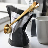 Close up of stainless steel coffee scoop and measuring spoon detail