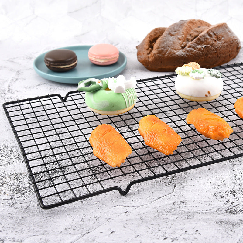 Carbon steel cooling rack holding pastries and baked goods