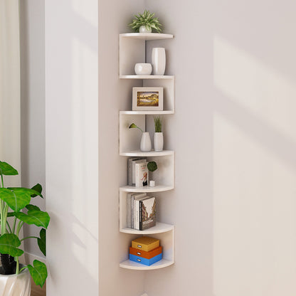 Black corner lattice shelf on a living room wall corner styled with candles and a small plant