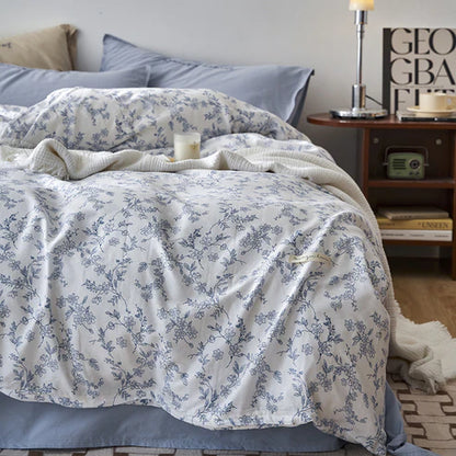 Double layer cotton bedding set blue floral pattern flat lay