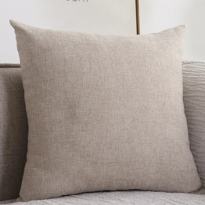 Beige cotton linen throw pillow on sofa