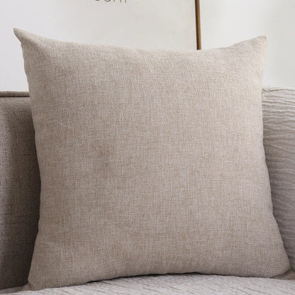 Beige cotton linen throw pillow on sofa