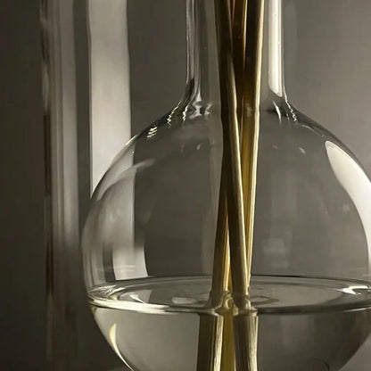 Close-up of Crystal Glass Reed Diffuser Bottle with Wooden Fragrance Sticks