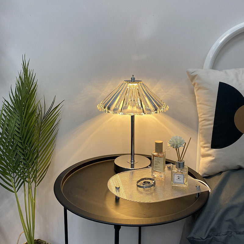 Crystal decorative table lamp glowing on a bedroom nightstand