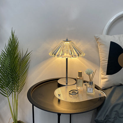 Crystal decorative table lamp glowing on a bedroom nightstand