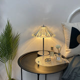 Crystal decorative table lamp glowing on a bedroom nightstand