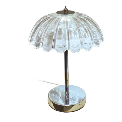 Crystal table lamp in warm white light mode on a wooden bedside table