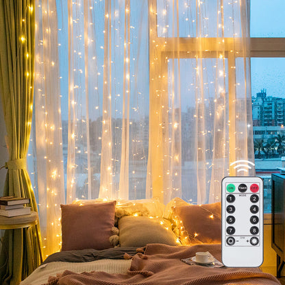 Curtain lamp with 300 warm white LEDs hanging above a bedroom headboard on a dark wall
