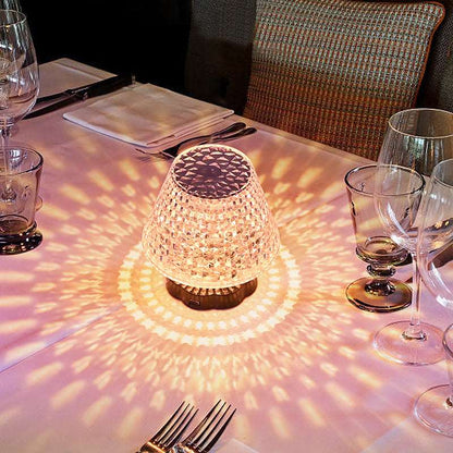 Diamond crystal table lamp with touch sensor glowing on a dark bar table