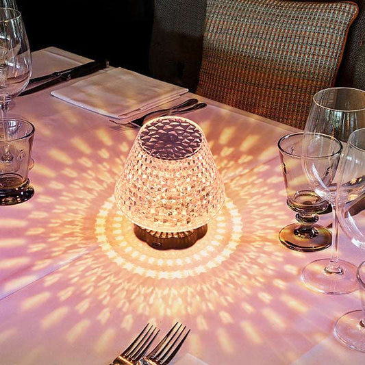 Diamond crystal table lamp with touch sensor glowing on a dark bar table