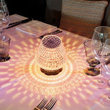 Diamond crystal table lamp with touch sensor glowing on a dark bar table
