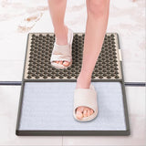 Disinfecting shoe sole cleaning mat in use at doorway entrance display