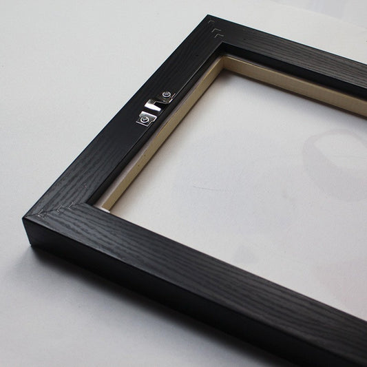 Close up of DIY wall picture frame corner assembly