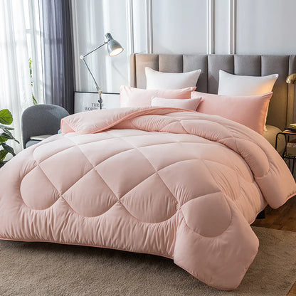 Down alternative quilted duvet insert in pink on bed