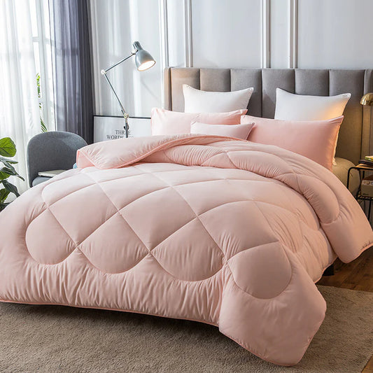 Down alternative quilted duvet insert in pink on bed