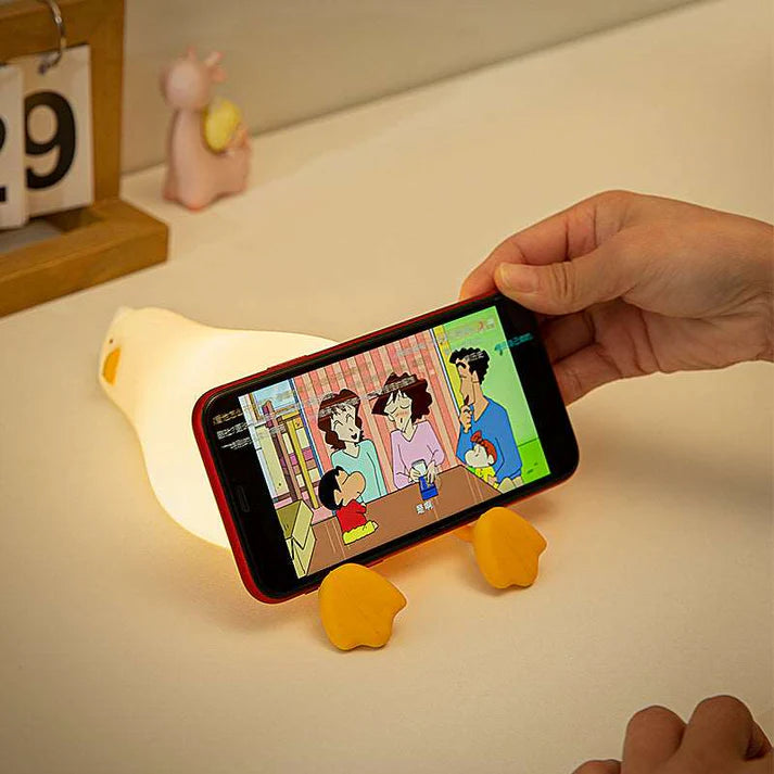 Duck night lamp glowing on children bedroom bedside table