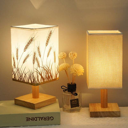 Energy saving LED light lamp with fabric shade sitting on a wooden desk