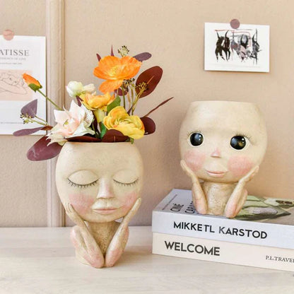 Face head sculpture planter holding fresh yellow flowers