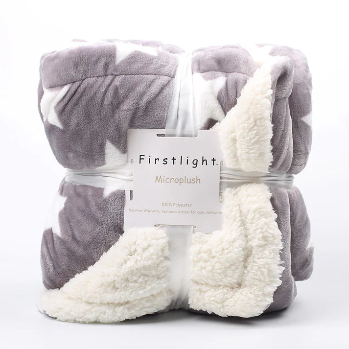 Fleece plush throw blanket folded in gray star pattern