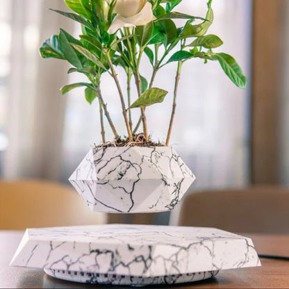 Floating magnetic plant pot styled with home decor items