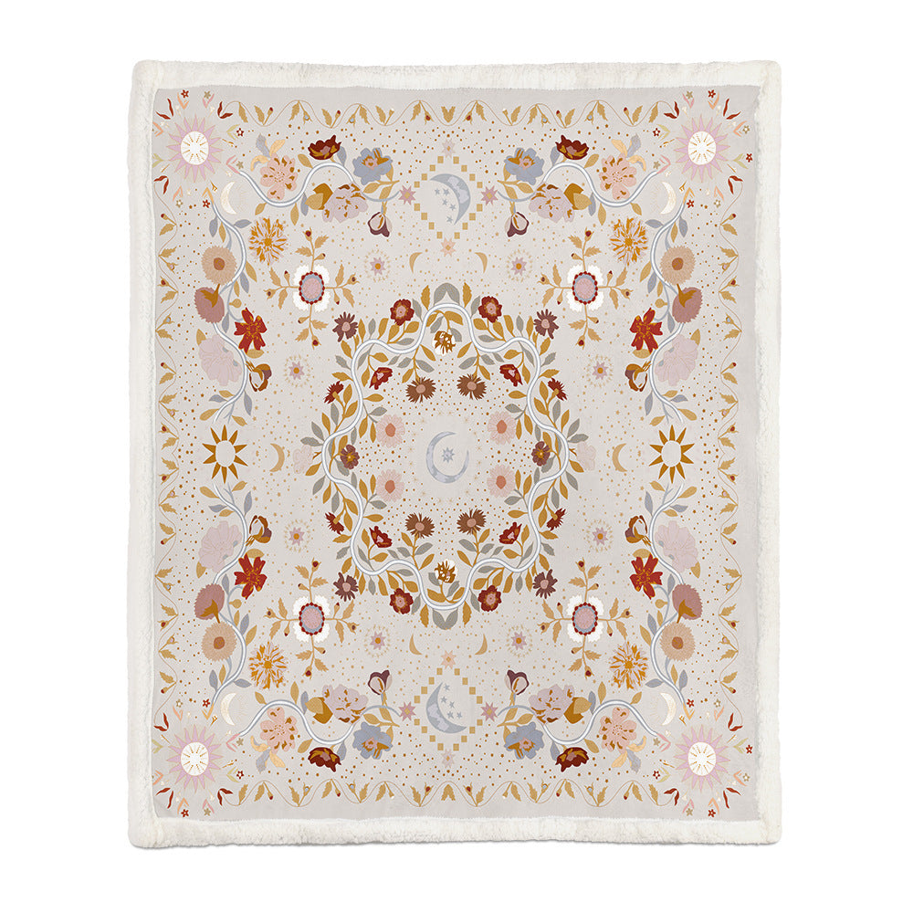 Large botanical floral blanket draped over a full sofa covering both armrests and the back
