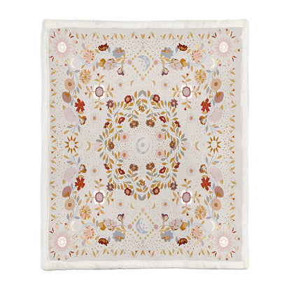 Large botanical floral blanket draped over a full sofa covering both armrests and the back
