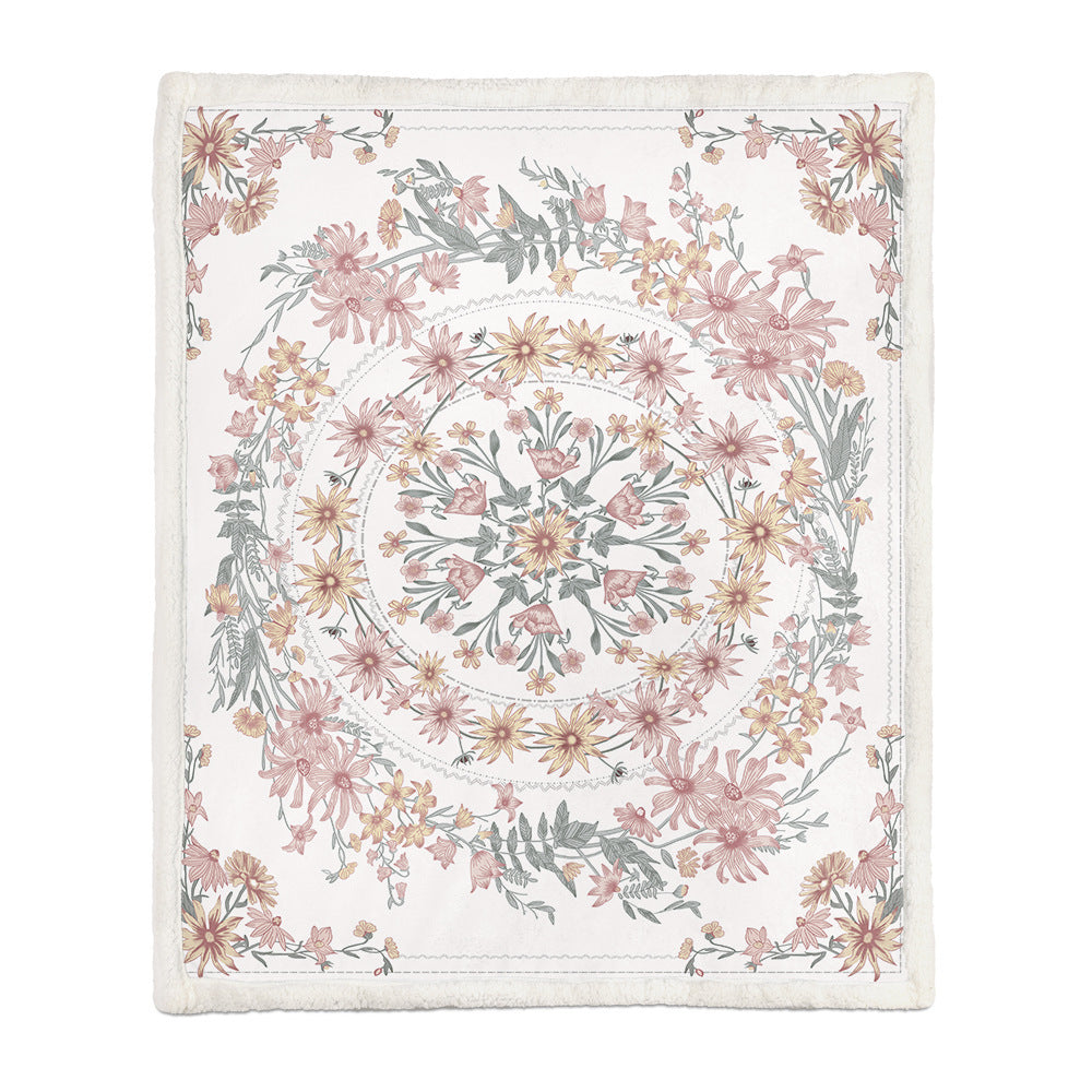 Medium floral throw blanket covering a person napping on a sofa in a living room
