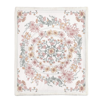 Medium floral throw blanket covering a person napping on a sofa in a living room
