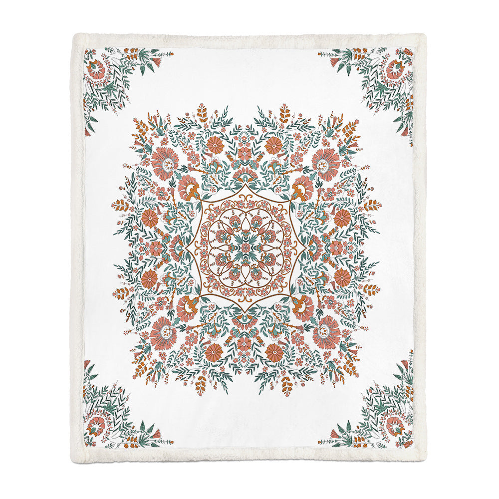 Two people sharing a medium floral throw blanket on a sofa on a cool evening
