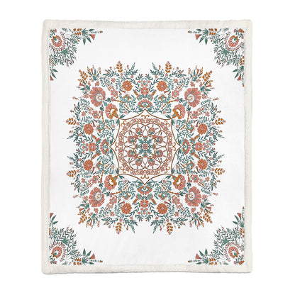 Two people sharing a medium floral throw blanket on a sofa on a cool evening

