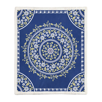 Small size floral throw blanket used as a lap blanket on an armchair covering waist to shin
