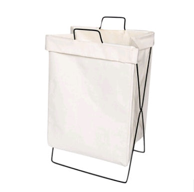 Collapsible fabric laundry basket standing upright in a bedroom corner holding a full load
