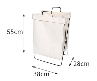 Large foldable fabric laundry hamper sitting on a closet floor holding sorted clothes
