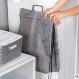 Foldable fabric laundry hamper collapsed completely flat for storage under a bed