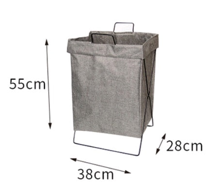 Collapsible fabric laundry basket in a dorm room beside a desk with clothes inside
