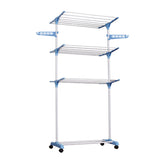 White folding drying rack with clothes in bedroom setting
