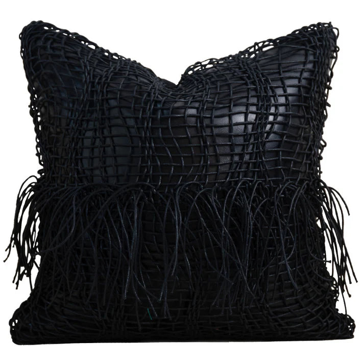 Black geometric cushion cover with textured woven design on sofa